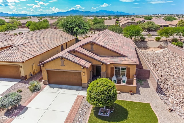 view of front of house with a garage and a mountain view