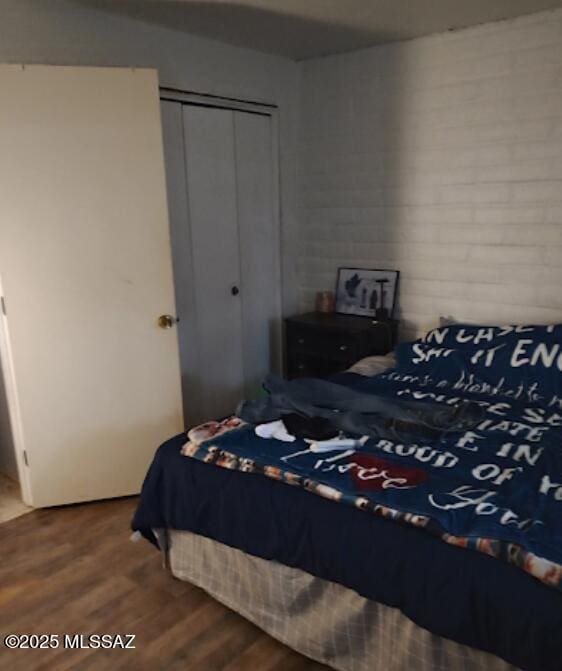 bedroom featuring hardwood / wood-style flooring and a closet