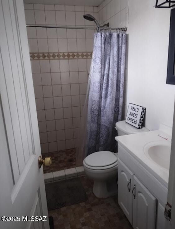 bathroom featuring vanity, toilet, and a shower with shower curtain