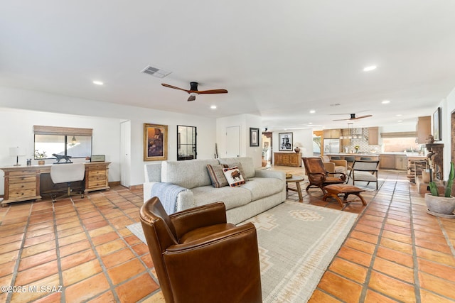 living room with ceiling fan and light tile patterned flooring