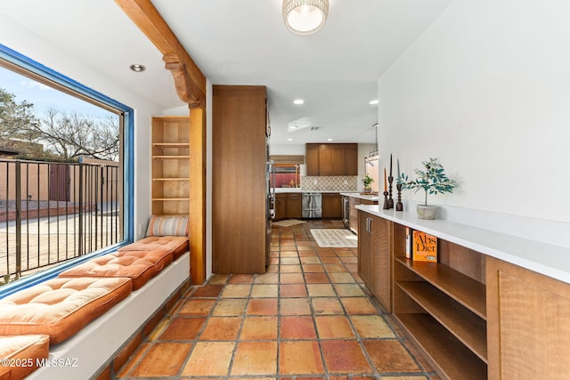 kitchen featuring tasteful backsplash, plenty of natural light, and stainless steel dishwasher