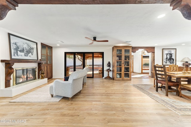 living room with light hardwood / wood-style flooring and ceiling fan