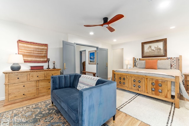 bedroom with light hardwood / wood-style floors and ceiling fan