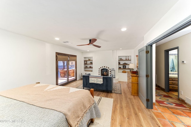 bedroom featuring access to exterior, light hardwood / wood-style flooring, and ceiling fan