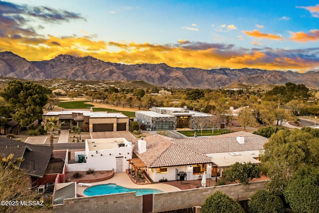 aerial view at dusk featuring a mountain view