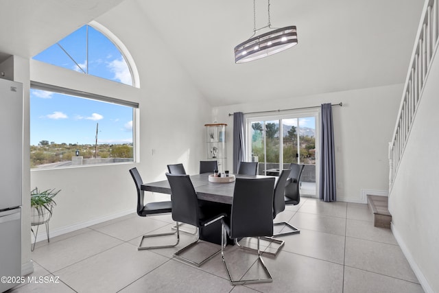 1061 W Roller Coaster Rd, Tucson, AZ 85704 - dining space featuring baseboards, high vaulted ceiling, light tile patterned flooring, and stairs