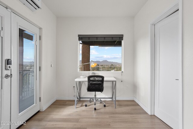 1061 W Roller Coaster Rd, Tucson, AZ 85704 - office space with a wall mounted air conditioner, light wood-type flooring, and baseboards