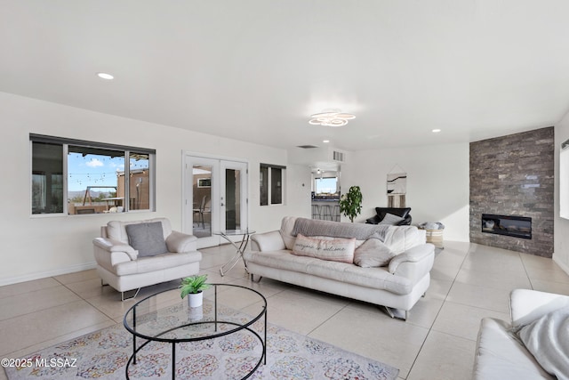 1061 W Roller Coaster Rd, Tucson, AZ 85704 - living area with visible vents, french doors, a fireplace, light tile patterned floors, and a healthy amount of sunlight