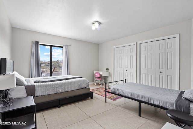 1061 W Roller Coaster Rd, Tucson, AZ 85704 - tiled bedroom featuring two closets and baseboards