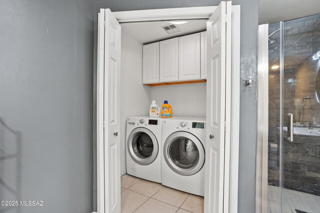 1061 W Roller Coaster Rd, Tucson, AZ 85704 - washroom featuring light tile patterned floors, visible vents, washing machine and dryer, and laundry area