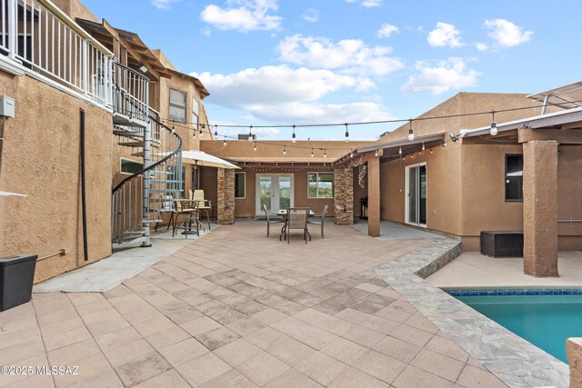 1061 W Roller Coaster Rd, Tucson, AZ 85704 - outdoor pool with a patio, stairway, outdoor dining area, and french doors