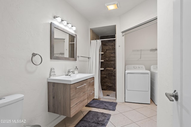 1061 W Roller Coaster Rd, Tucson, AZ 85704 - bathroom featuring tile patterned flooring, washing machine and dryer, toilet, a stall shower, and vanity