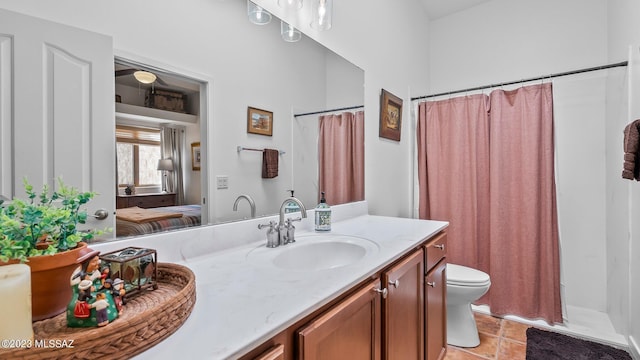 bathroom featuring tile patterned flooring, vanity, a shower with shower curtain, and toilet