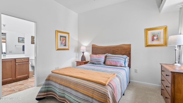 carpeted bedroom featuring ensuite bath