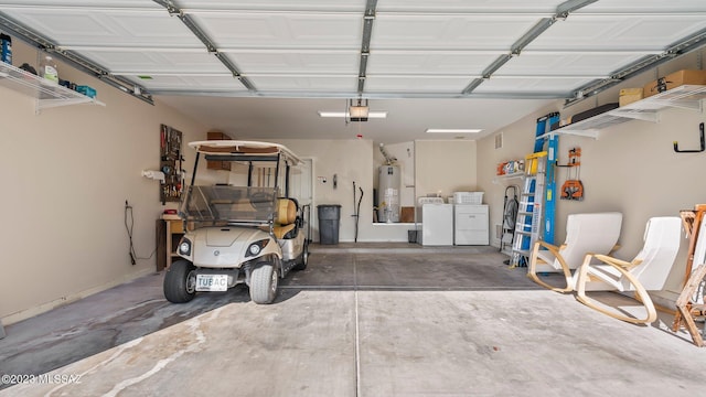 garage featuring a garage door opener, gas water heater, and washer and dryer