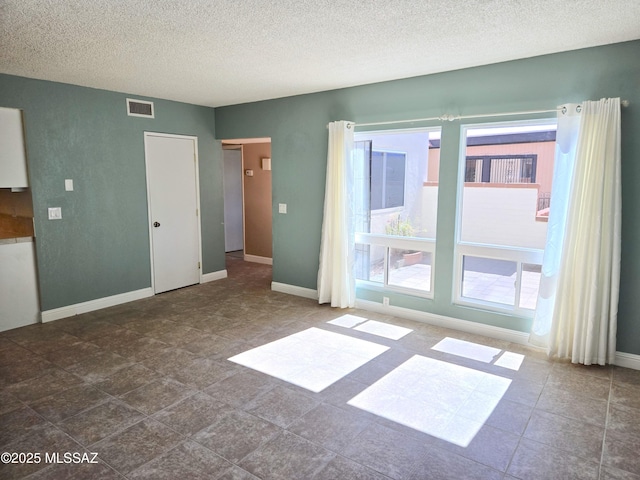 290 N Paseo De Los Conquistadores, Green Valley, AZ 85614 - spare room featuring a textured ceiling and baseboards
