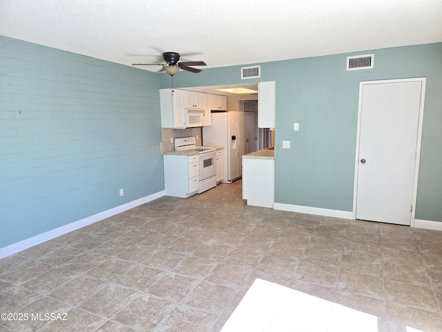 290 N Paseo De Los Conquistadores, Green Valley, AZ 85614 - unfurnished living room with ceiling fan, baseboards, and a textured ceiling