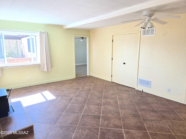 290 N Paseo De Los Conquistadores, Green Valley, AZ 85614 - spare room with ceiling fan, beamed ceiling, baseboards, and dark tile patterned floors