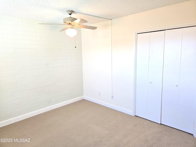290 N Paseo De Los Conquistadores, Green Valley, AZ 85614 - unfurnished bedroom featuring carpet flooring, a closet, a textured ceiling, baseboards, and a ceiling fan