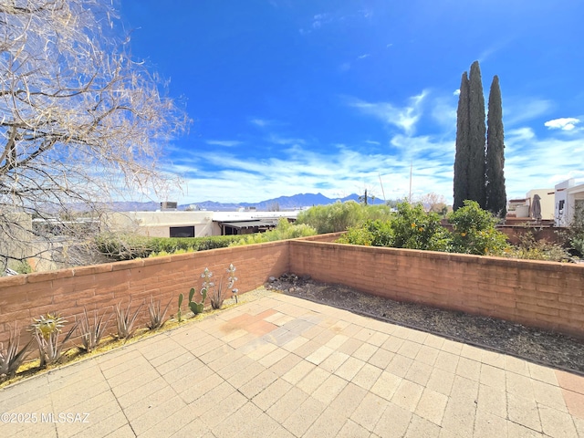 view of patio / terrace featuring a fenced backyard and a mountain view