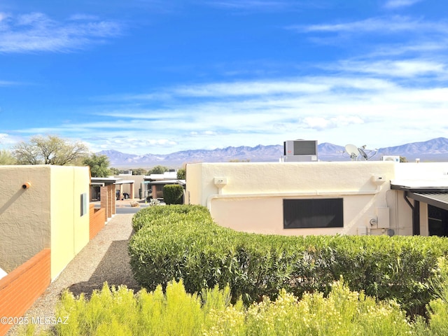 290 N Paseo De Los Conquistadores, Green Valley, AZ 85614 - view of property exterior with a mountain view, central AC unit, and stucco siding