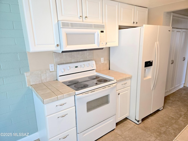 290 N Paseo De Los Conquistadores, Green Valley, AZ 85614 - kitchen featuring white appliances, tile countertops, and white cabinets