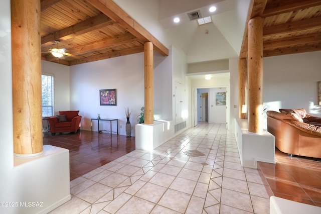 foyer featuring beam ceiling, light tile patterned floors, visible vents, wooden ceiling, and ornate columns