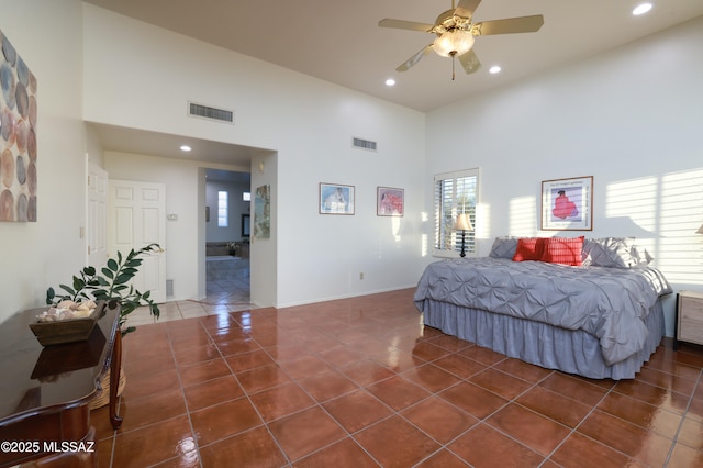 bedroom with recessed lighting, visible vents, dark tile patterned floors, and a high ceiling