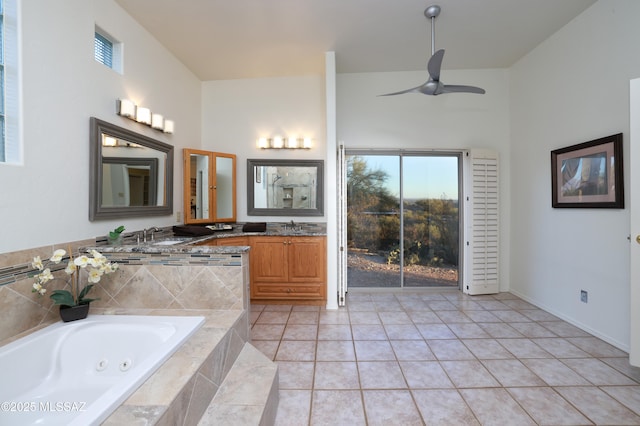 bathroom featuring tile patterned flooring, ceiling fan, vanity, and a whirlpool tub