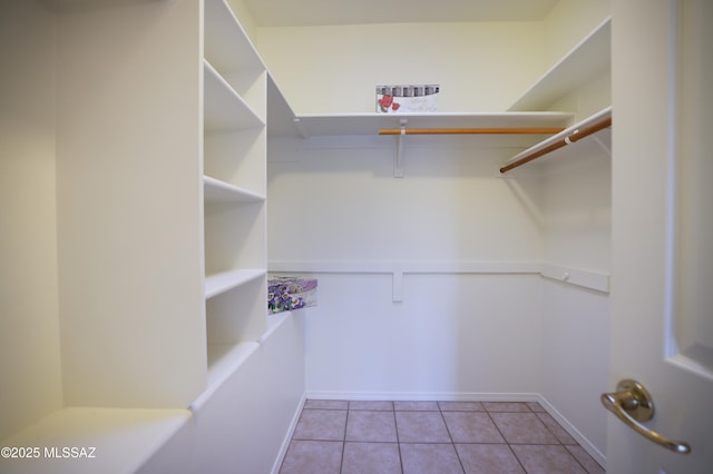 walk in closet with tile patterned floors