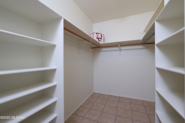 spacious closet featuring light tile patterned floors