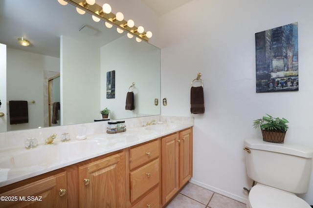 full bath featuring double vanity, a sink, toilet, and tile patterned floors