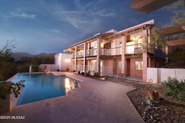 view of swimming pool featuring a fenced in pool, a patio area, and fence