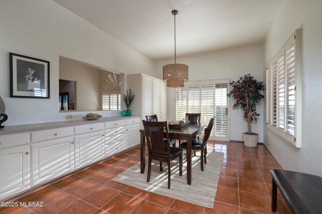dining space with dark tile patterned flooring