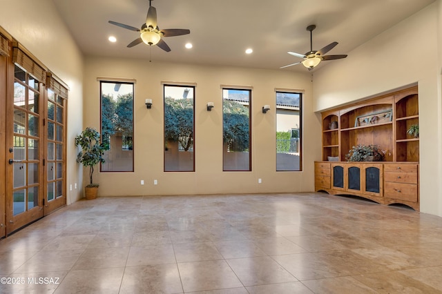 unfurnished living room featuring light tile patterned flooring and ceiling fan