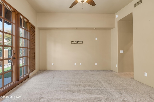 carpeted empty room featuring ceiling fan