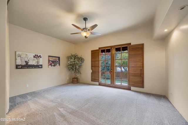 empty room with french doors, ceiling fan, and carpet flooring