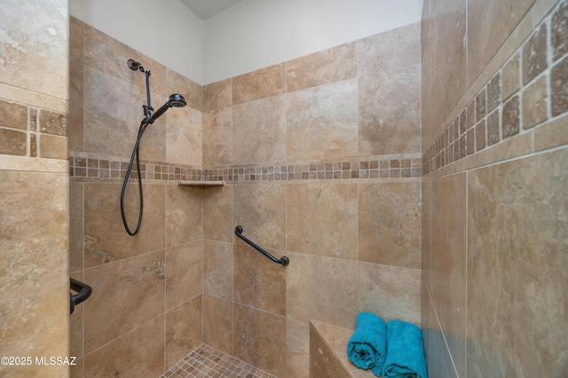 bathroom with a tile shower