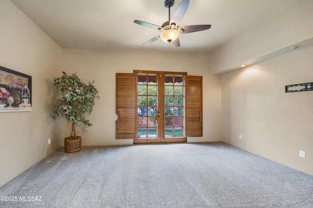 carpeted empty room with french doors and ceiling fan