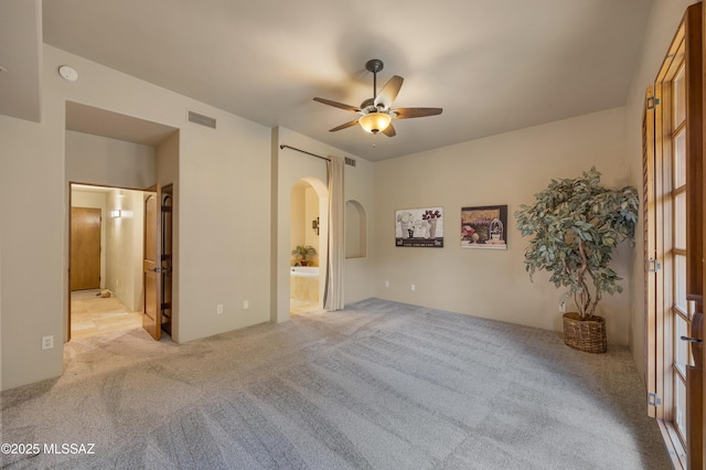 carpeted spare room featuring ceiling fan