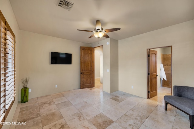 tiled empty room with ceiling fan