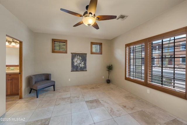 living area with light tile patterned flooring and ceiling fan