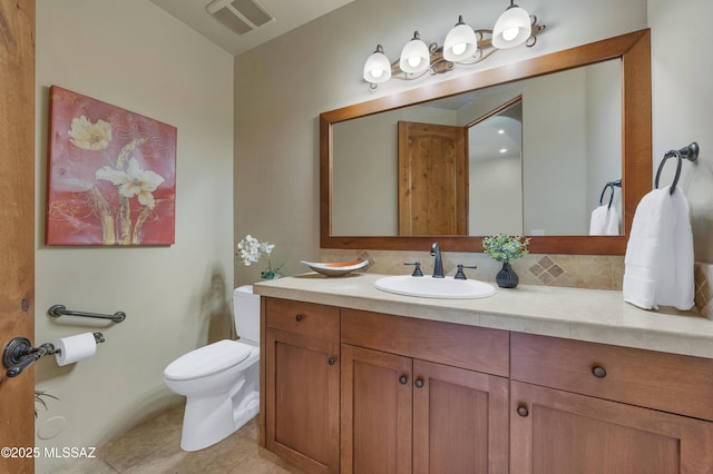 bathroom featuring vanity, tile patterned floors, and toilet