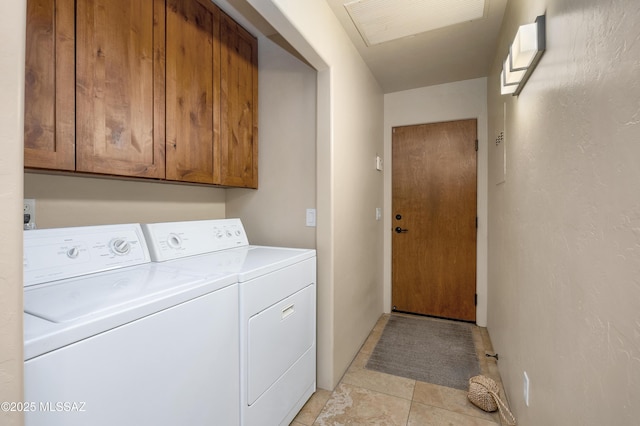 laundry area featuring cabinets, washer and clothes dryer, and light tile patterned floors