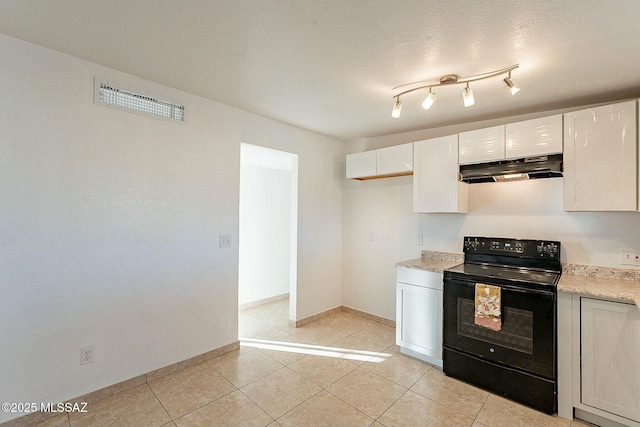 kitchen with light tile patterned floors, white cabinets, and black / electric stove