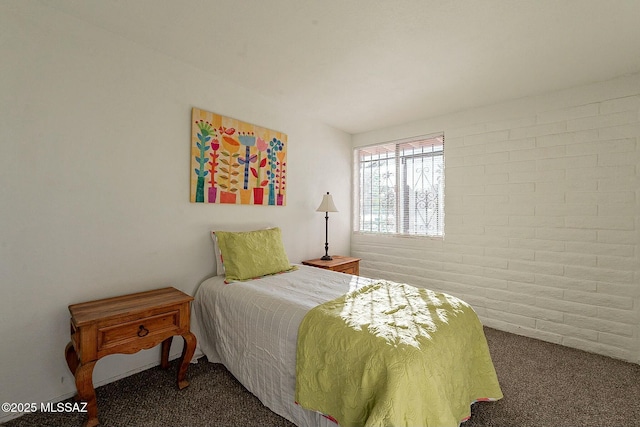 carpeted bedroom featuring brick wall