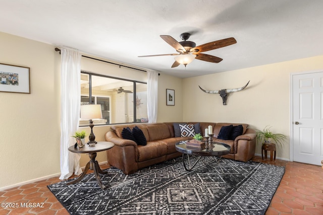 living room with ceiling fan and tile patterned floors