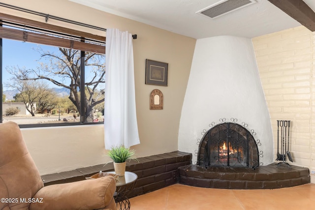 living area with tile patterned floors and a fireplace