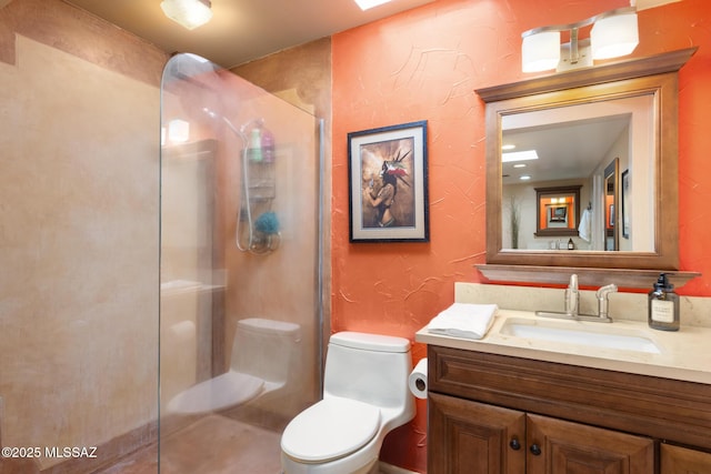 bathroom with walk in shower, vanity, and toilet