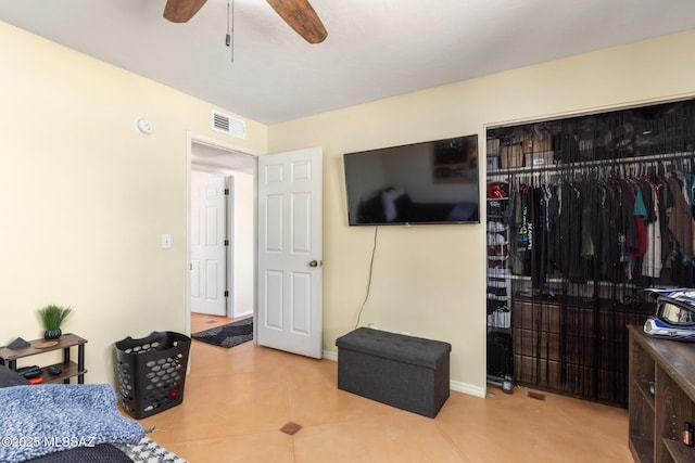 bedroom with ceiling fan and a closet